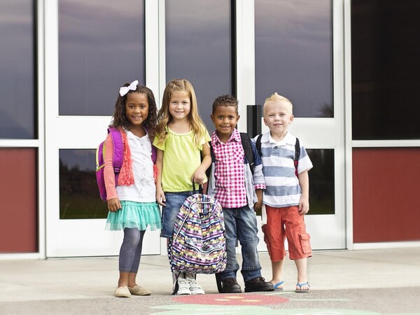children standing in front of school