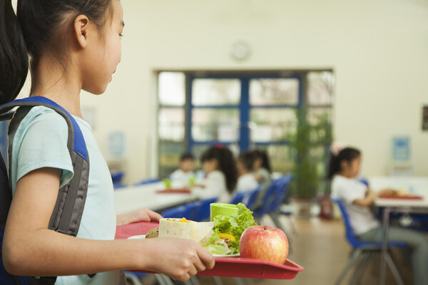 Child with food in school cafeteria