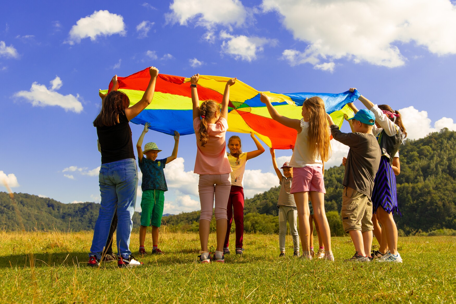 Photo of children playing with colourful parachute