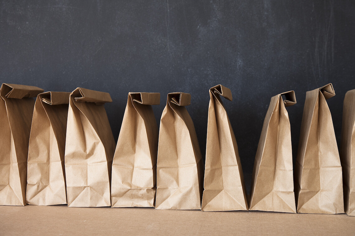 School lunch bags and blackboard