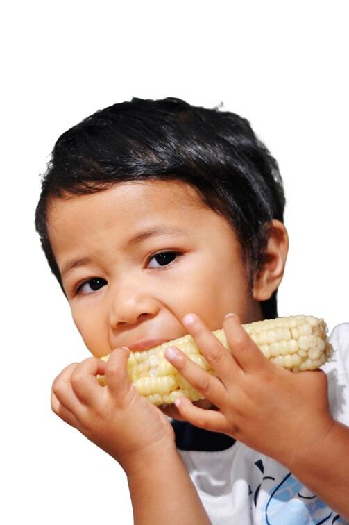 child eating corn